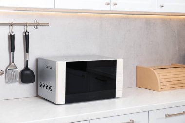 Mutfak tezgahında kapalı mikrodalga fırın.