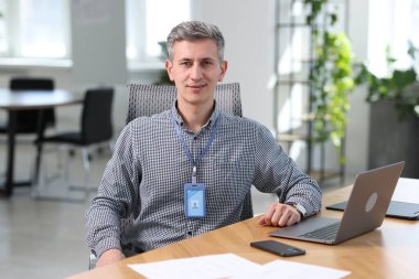 Ofiste dizüstü bilgisayarla çalışan mühendisin portresi