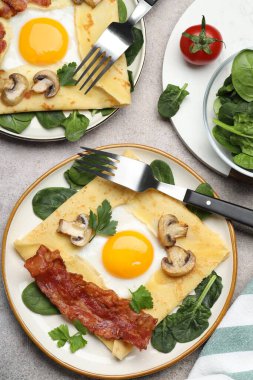 Yumurtalı, pastırmalı ve mantarlı leziz krepler gri masada servis ediliyor. Breton galeti