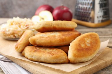 Lezzetli kızarmış pirinçler (doldurulmuş turtalar) ve ahşap masada elmalar, yakın plan.