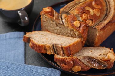 Muzlu ekmeği fındıklı kes ve siyah masaya kahve koy, yakın plan.