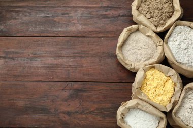 Tahta masadaki kağıt torbalarda farklı türde un var. Metin için boşluk