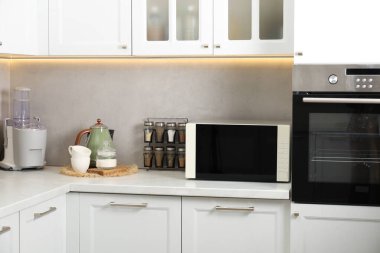 Mutfak tezgahında kapalı mikrodalga fırın.