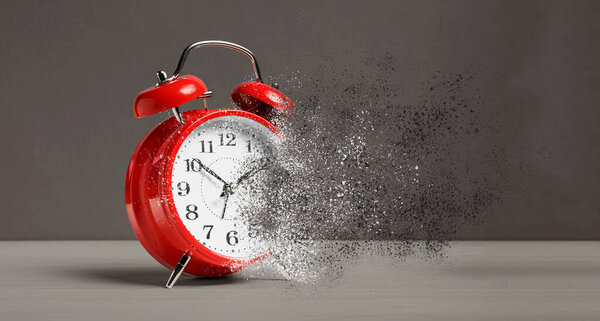 Alarm clock dissolving on wooden table against grey background, banner. Time is running out