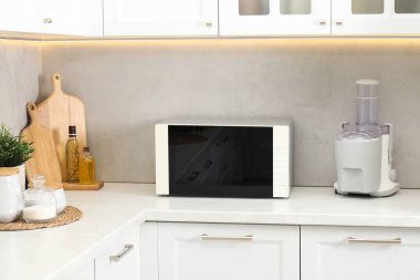 Mutfak tezgahında kapalı mikrodalga fırın.