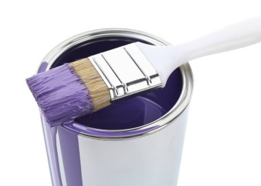 Can of violet paint and brush isolated on white