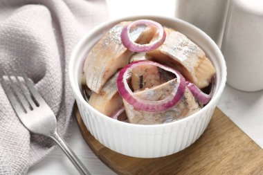 Beyaz masada soğanlı lezzetli ringa balıkları, yakın plan.