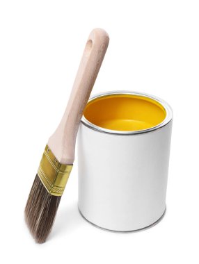 Can of yellow paint and brush isolated on white