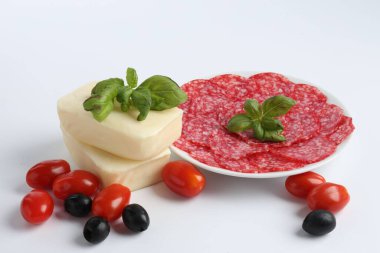 Pizza yapıyorum. Farklı malzemeler beyaza izole edilmiş.