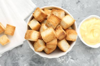 Lezzetli çıtır kıtır ekmek ve gri desenli masada sos.