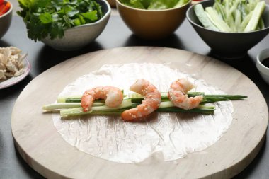 Pilav kağıtları ve koyu gri masa üzerindeki farklı malzemeler, yakın plan.