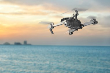 Denizin üzerinde uçan kameralı bir dron. Gözetleme için insansız hava aracı