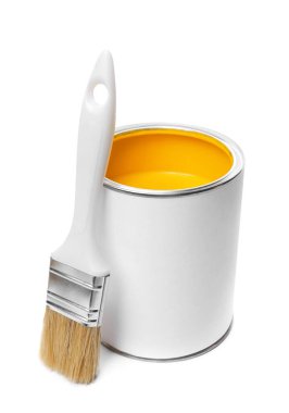 Can of yellow paint and brush isolated on white