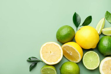 Taze limon ve limon soluk yeşil arka planda, düz yerde. Metin için boşluk
