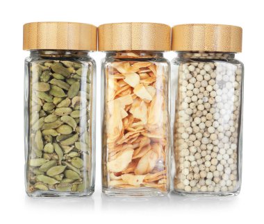 Beyaz kavanozlardaki farklı aromatik baharatlar.