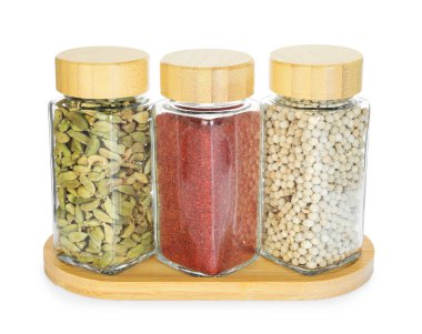 Beyaz kavanozlardaki farklı aromatik baharatlar.