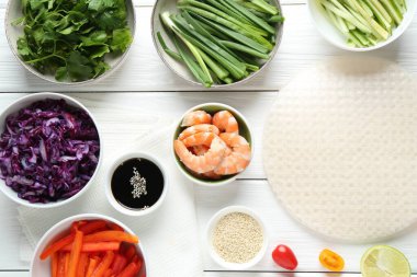 Pirinç kağıt çarşaflar ve beyaz ahşap masa üzerindeki farklı malzemeler.