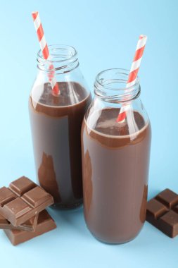 Lezzetli çikolatalı süt ve açık mavi arkaplan parçaları.