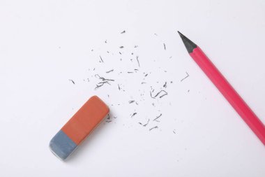 Eraser, pencil and scraps on white background, flat lay