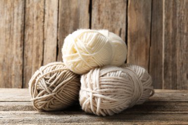 Skeins of yarn on wooden table, closeup