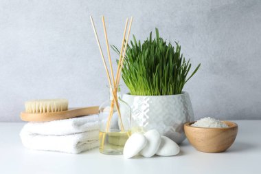 Beyaz masa üzerinde buğday otu ve deniz tuzu içeren spa kompozisyonu