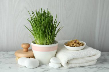Spa composition with wheatgrass on white marble table
