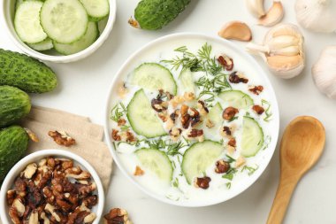 Beyaz masada dereotlu, fındıklı ve sarımsaklı leziz salatalık çorbası.