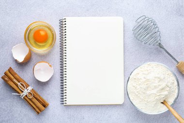 Boş yemek tarifi kitabı, çırpma makinesi ve ürünler ışık masasında. Tasarım için model