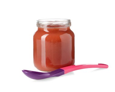 Bebek maması. Cam kavanozda lezzetli püre ve beyaza izole edilmiş kaşık.