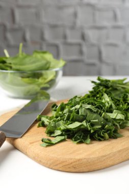 Beyaz ahşap masada taze at ve bıçak kes, yakın plan.