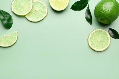 Taze limon ve yapraklar soluk yeşil arka planda, düz yatıyordu. Metin için boşluk