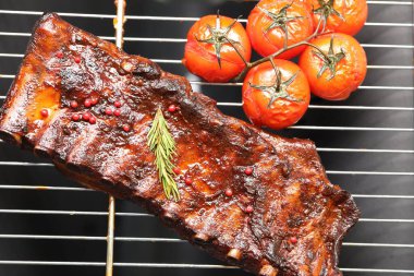 Biberiyeli domuz pirzolası ve ızgarada domates.