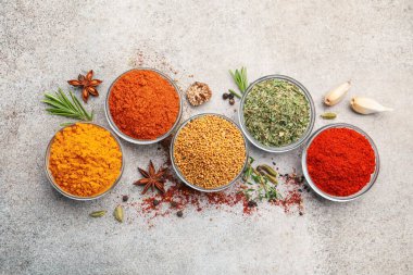 Açık gri masada farklı aromatik baharatlar var.