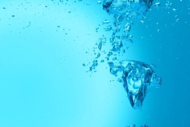 Açık mavi arkaplanda birçok su kabarcığı, yakın plan