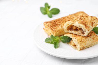 Lezzetli elmalı turtalar ve beyaz fayanslı masada nane şekeri, yakın plan. Metin için boşluk