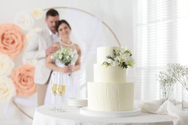 Mutlu evli çift içeride, düğün pastasına ve masadaki şampanya bardaklarına odaklan.