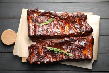 Siyah ahşap masada biberiyeli domuz pirzolası.