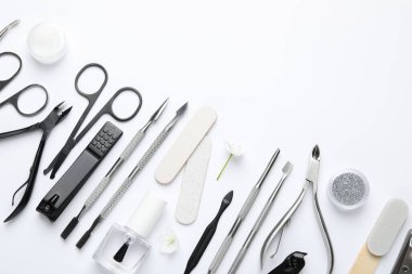 Beyaz arka planda farklı manikür aletleri var. Metin için boşluk