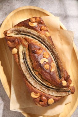 Ev yapımı muz ekmeği, fındıklı gri masa, üst manzara.