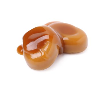 Lezzetli tatlı şekerler ve beyaz üzerine izole edilmiş karamel sosu