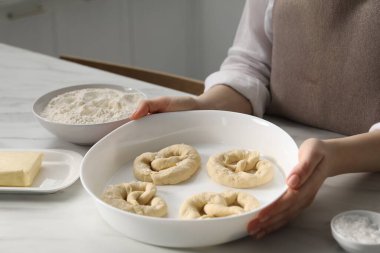 Mutfaktaki masada pişmemiş krakerleri olan kadın, yakın plan.