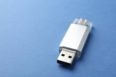 Mavi arka planda bir flaş bellek, yakın plan. Metin için boşluk