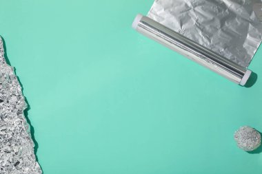 Turkuaz arka planda alüminyum folyo, düz. Metin için boşluk