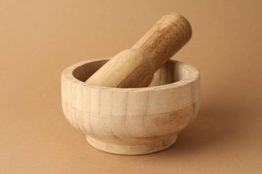 Açık kahverengi zemin üzerinde ahşap harç ve tokmak, yakın çekim