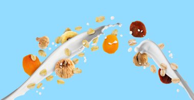 Süt sıçraması, yulaf ezmesi ve açık mavi arka planda kurutulmuş meyve. Pankart tasarımı