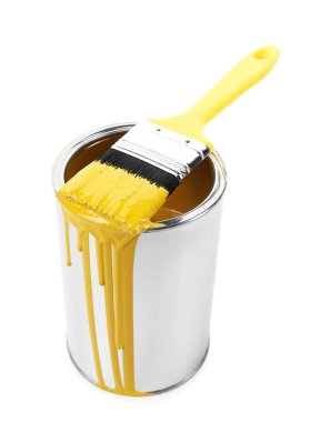 Can of yellow paint and brush isolated on white