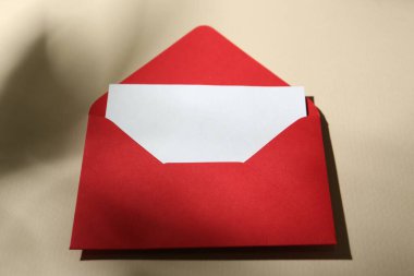 Bej arkaplan üzerine boş tebrik kartı ve kağıt zarf, yakın plan