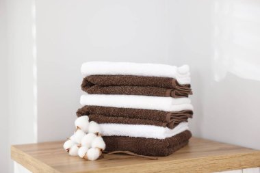 İçerideki ahşap dolapta bir yığın temiz havlu ve pamuk var.