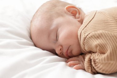 Evdeki yatakta uyuyan tatlı bir bebek.