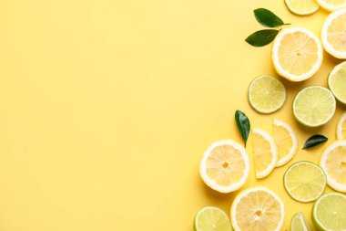 Sarı arka planda limon ve limon dilimleri. Metin için boşluk